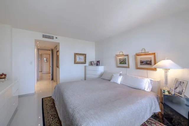 a bedroom with a bed and a lamp