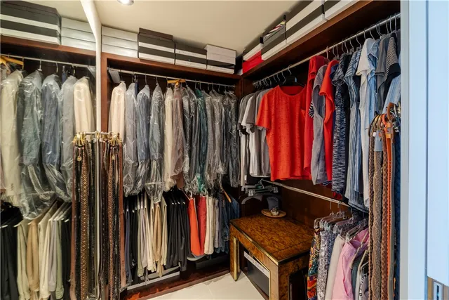 a view of walk in closet with clothes
