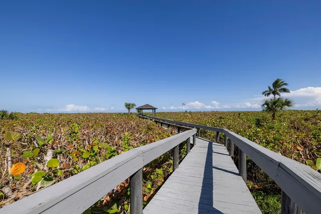 a view of balcony with wooden floor and a seating space