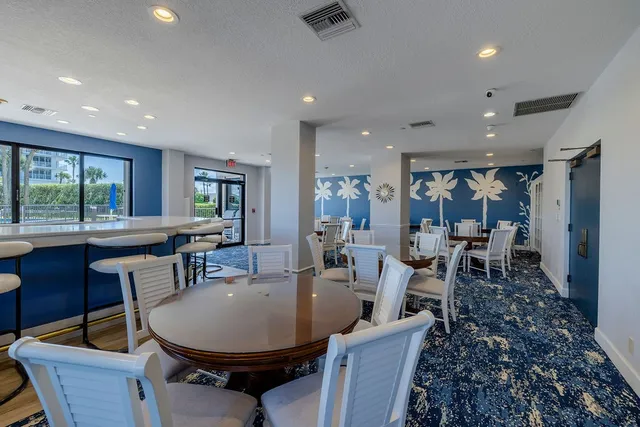 a dining room with furniture a large window and a table