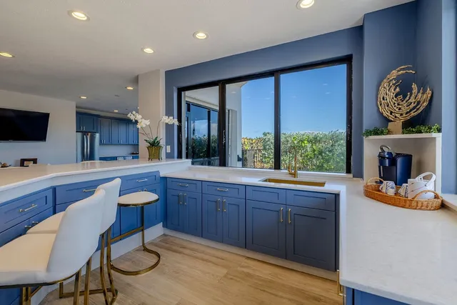 a large kitchen with wooden cabinets and stainless steel appliances