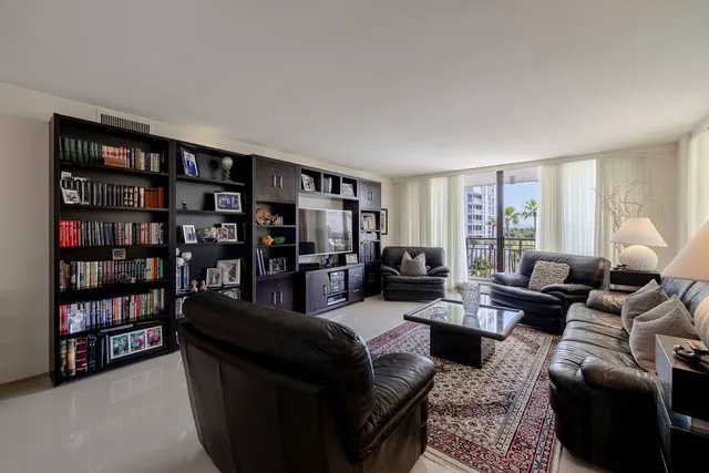 a living room with furniture and a book shelf