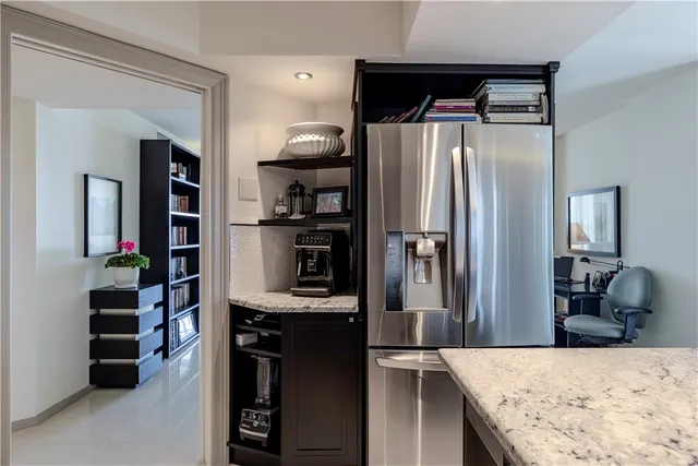 a kitchen with a refrigerator and cabinets