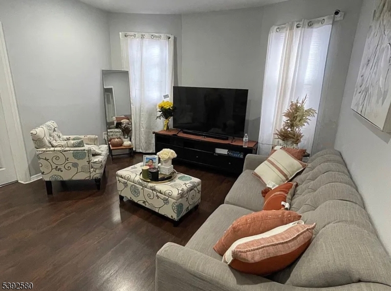 325 Woodside Avenue Newark, NJ 07104 - Photo 2 of 4 a living room with furniture and a flat screen tv