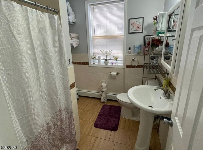 325 Woodside Avenue Newark, NJ 07104 - Photo 3 of 4 a bathroom with a sink and toilet