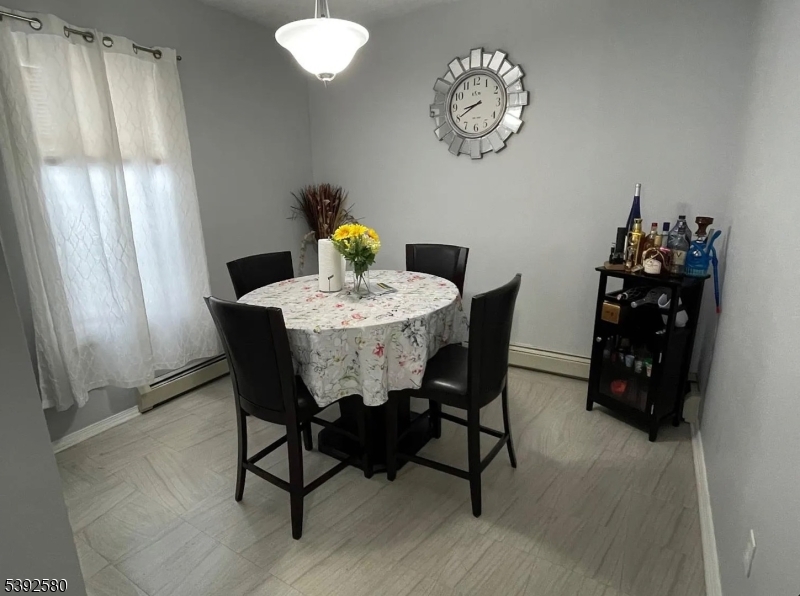 325 Woodside Avenue Newark, NJ 07104 - Photo 4 of 4 a view of a dining room with furniture and chandelier