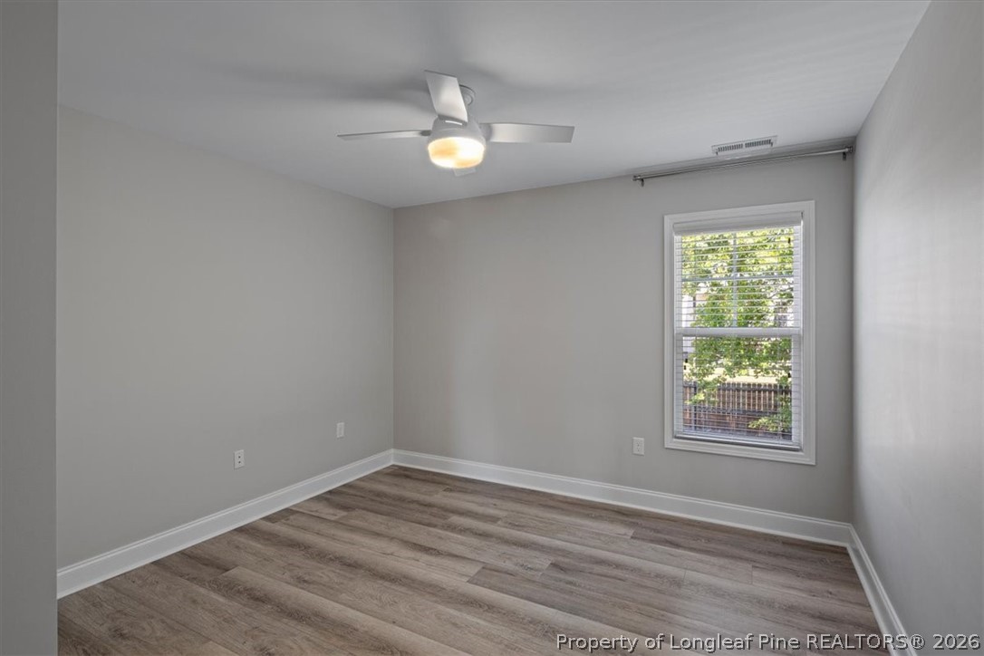 134 Huzzas Circle Cameron, NC 28326 - Photo 16 of 31 a view of an empty room with wooden floor and a window