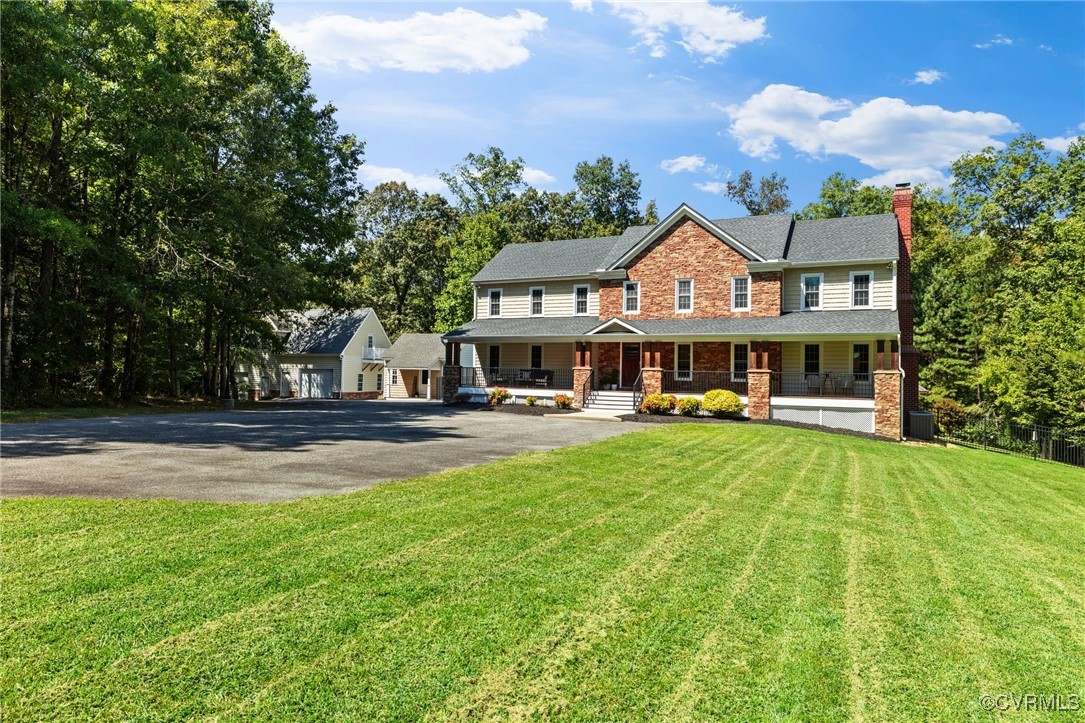 a front view of a house with yard and green space