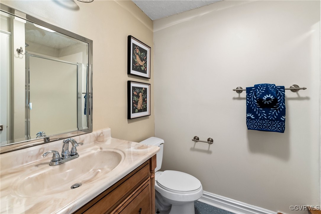 9850 Taylor Road Chesterfield, VA 23838 - Photo 21 of 38 a bathroom with a granite countertop toilet a sink and mirror
