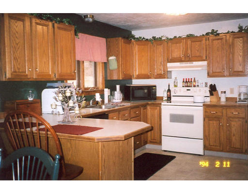 106 Clark Road Sturbridge, MA 01518 - Photo 5 of 6 a kitchen with a stove a sink and a refrigerator