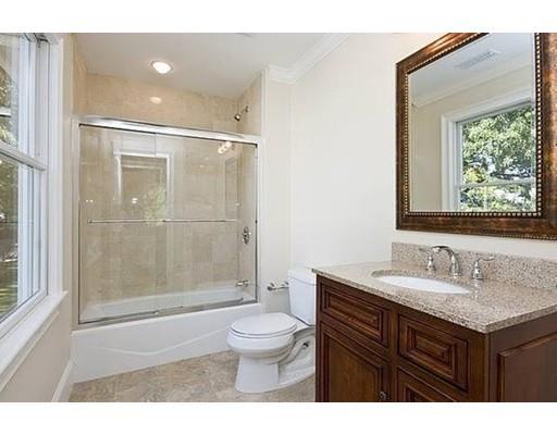 157 Dickerman Road Newton, MA 02461 - Photo 17 of 25 a bathroom with a granite countertop sink toilet a mirror and shower
