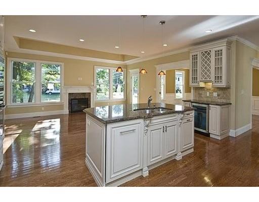 157 Dickerman Road Newton, MA 02461 - Photo 7 of 25 a open kitchen with granite countertop a stove top oven a sink with wooden cabinets and floor