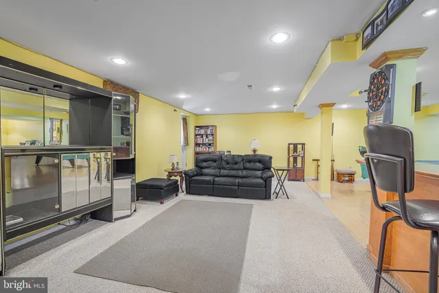 a view of a living room with furniture and a flat screen tv