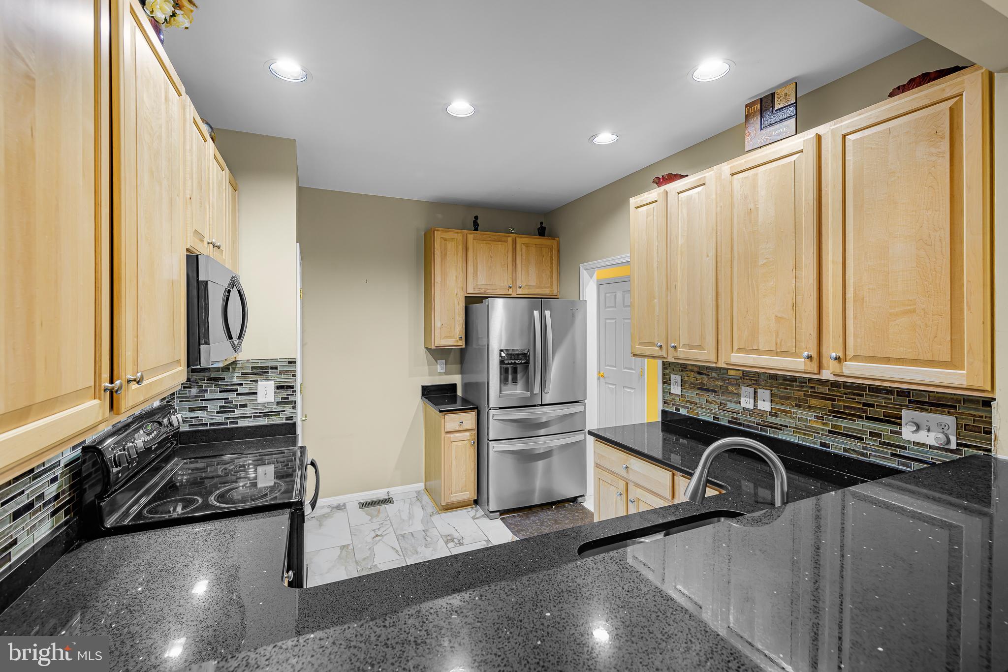 433 Pierce Run Newark, DE 19702 - Photo 8 of 43 a kitchen with stainless steel appliances granite countertop a refrigerator sink and stove