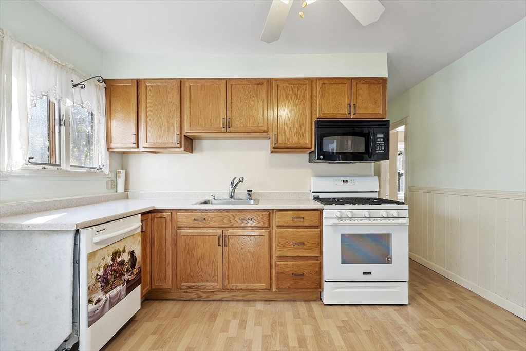 111 Central Street Concord, MA 01742 - Photo 11 of 42 a kitchen with stainless steel appliances granite countertop a stove a sink and a microwave