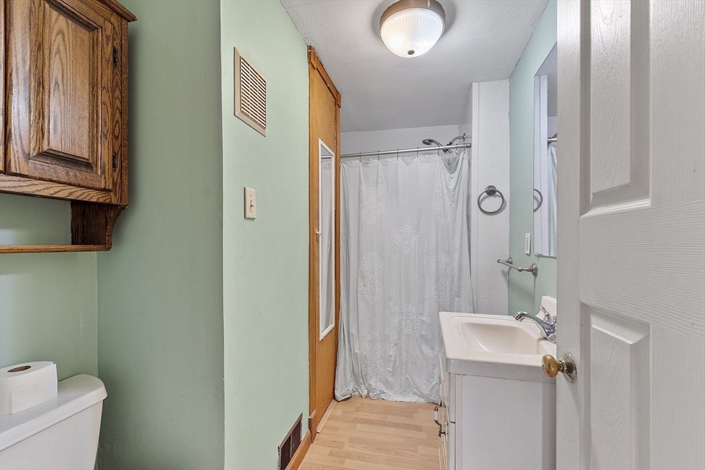111 Central Street Concord, MA 01742 - Photo 13 of 42 a bathroom with a granite countertop sink toilet and shower