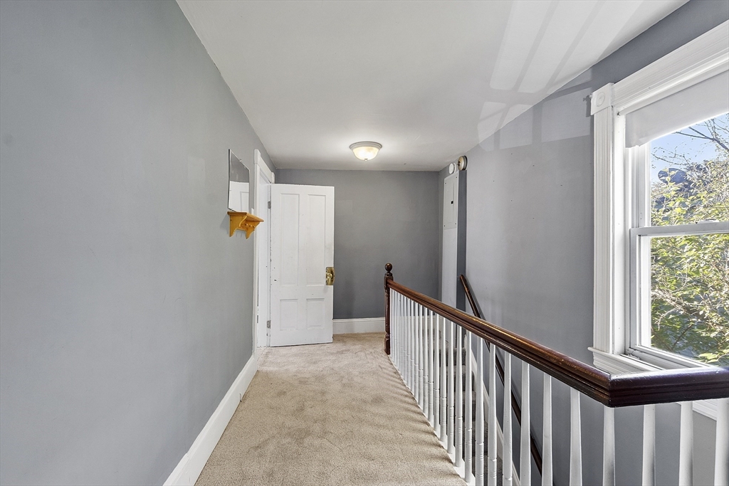 111 Central Street Concord, MA 01742 - Photo 19 of 42 a view of a hallway with wooden floor and staircase