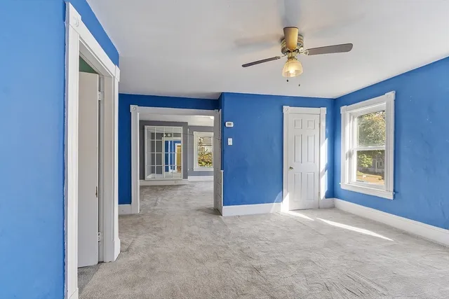 an empty room with windows and closet