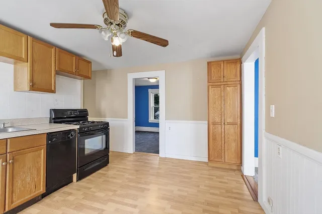 a kitchen with stainless steel appliances granite countertop a refrigerator a stove and a sink