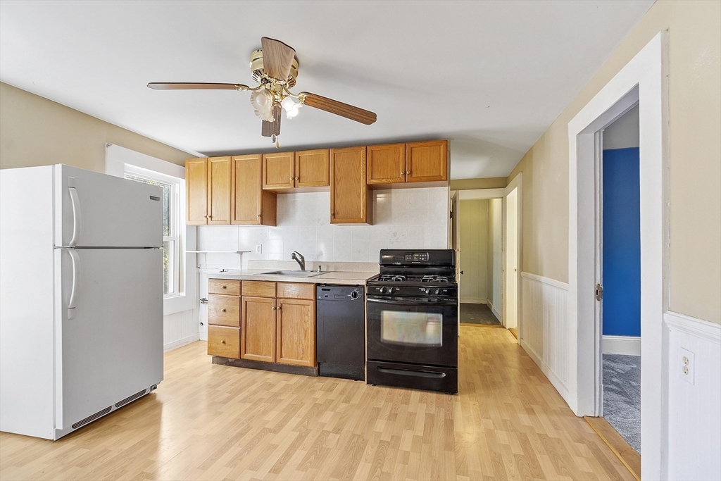 111 Central Street Concord, MA 01742 - Photo 27 of 42 a kitchen with stainless steel appliances granite countertop a refrigerator a stove and a sink