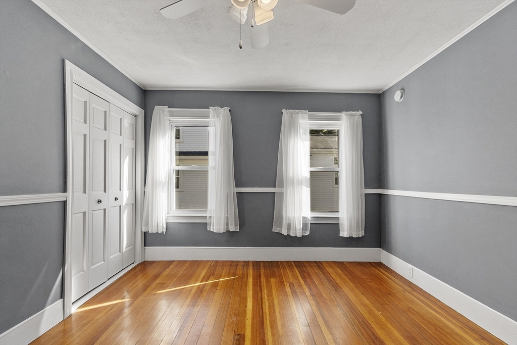 111 Central Street Concord, MA 01742 - Photo 8 of 42 a view of an empty room with wooden floor and a window