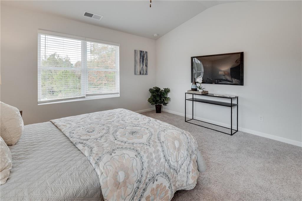 7439 Knoll Hollow Road Lithonia, GA 30058 - Photo 14 of 29 a bedroom with a bed television on desk and a window