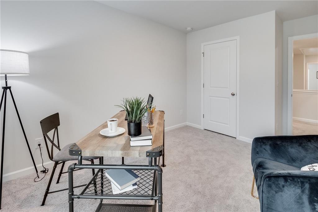 7439 Knoll Hollow Road Lithonia, GA 30058 - Photo 20 of 29 a dining room with furniture and wooden floor