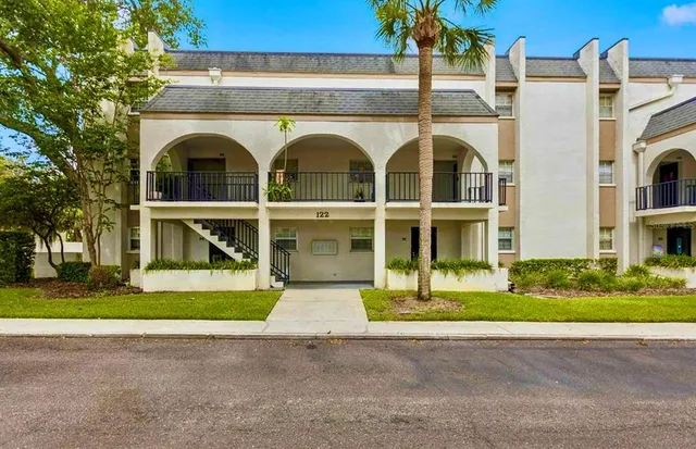 a view of a brick house with a yard
