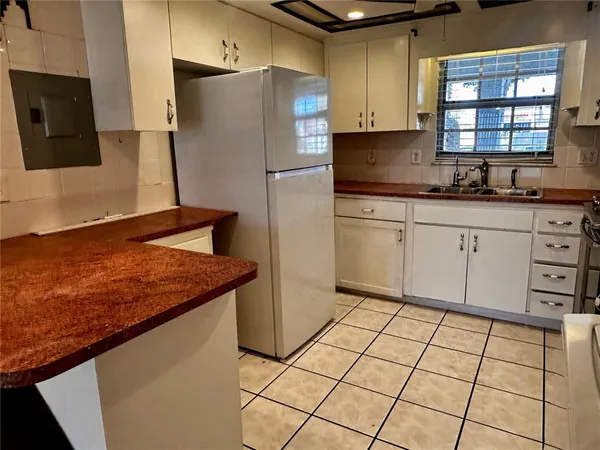 a kitchen with stainless steel appliances granite countertop a refrigerator sink and cabinets