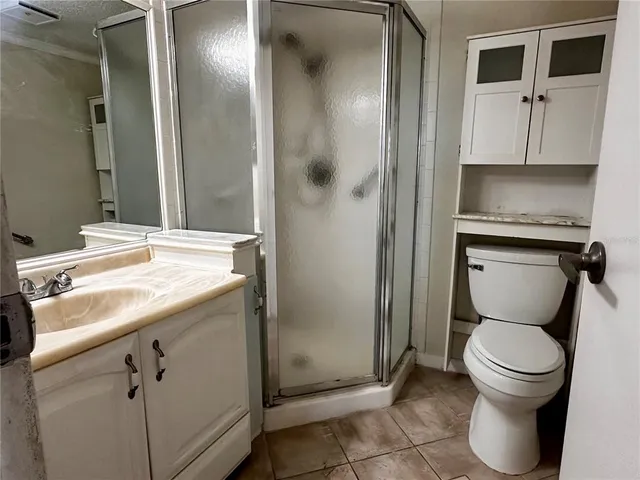 a bathroom with a toilet sink and shower