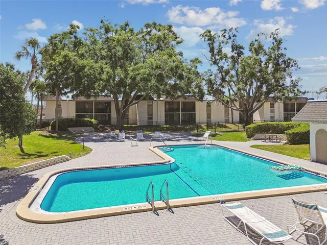 a swimming pool with outdoor seating and yard