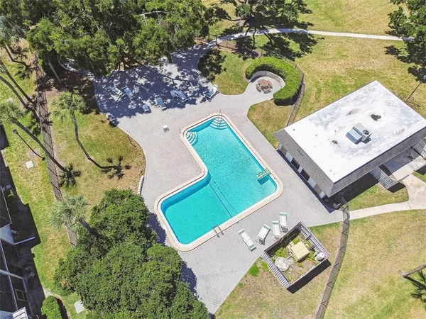 an aerial view of a swimming pool with yard