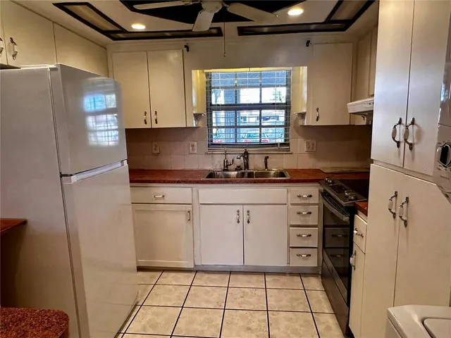 a kitchen with stainless steel appliances a refrigerator sink and cabinets