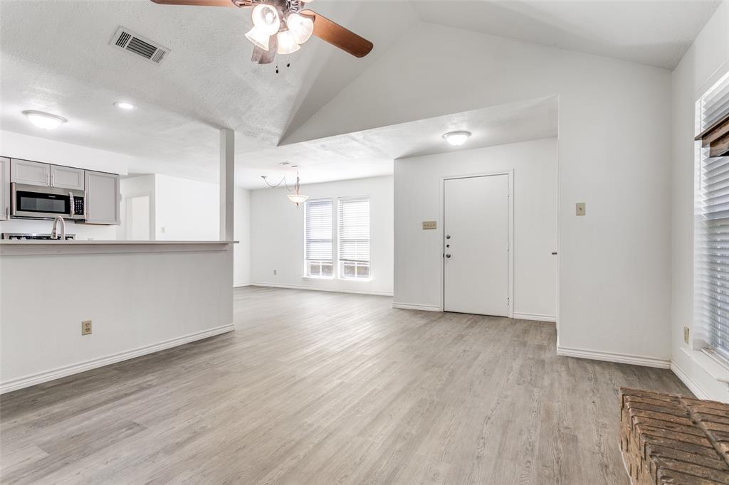 2121 Stone Moss Lane Grapevine, TX 76051 - Photo 4 of 12 View from the living room showing front door, dining room and kitchen with eat-in bar.