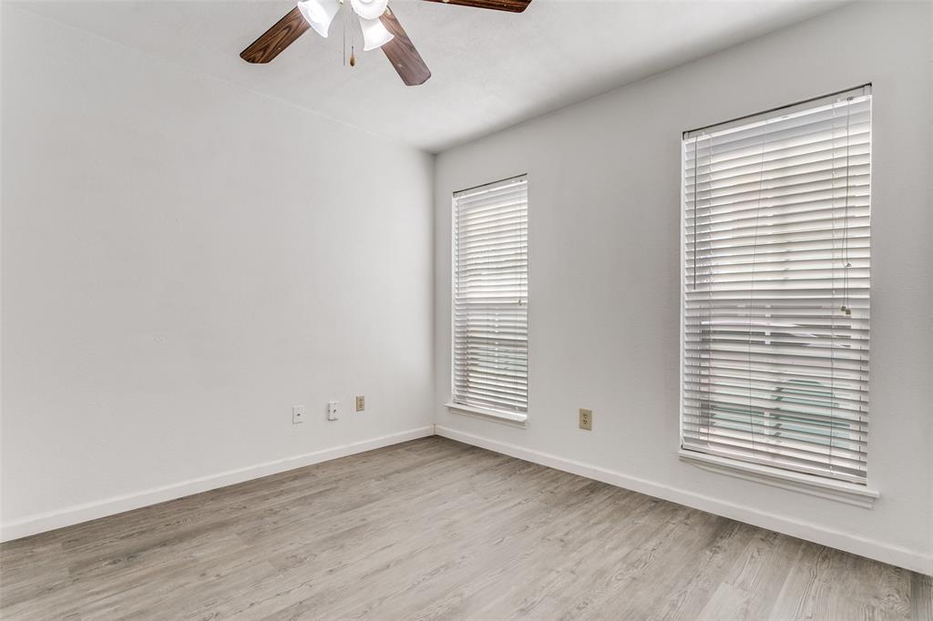 2121 Stone Moss Lane Grapevine, TX 76051 - Photo 10 of 12 Downstairs guest bedroom with two large windows, large closet and ceiling fan