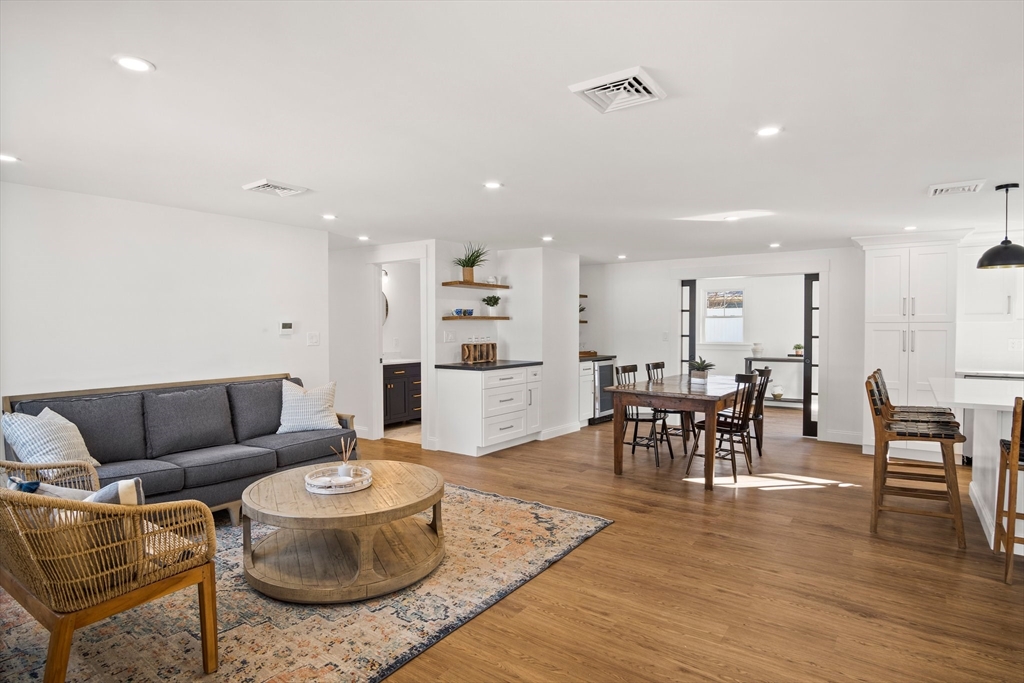 4 Jethro Street Maynard, MA 01754 - Photo 15 of 29 a living room with furniture and a dining table with wooden floor