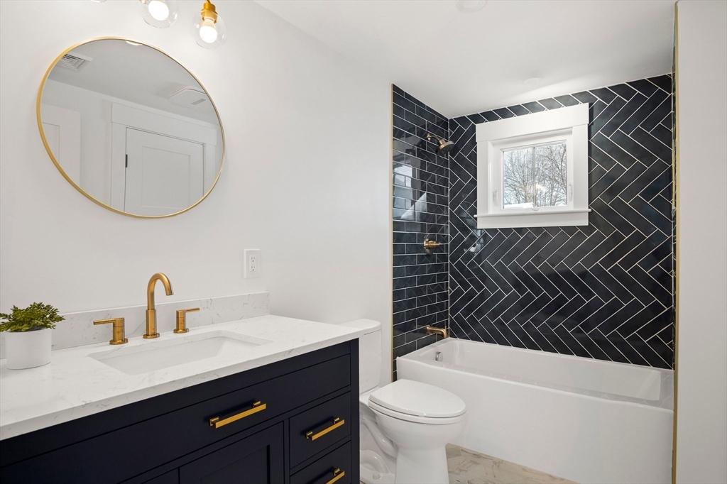 4 Jethro Street Maynard, MA 01754 - Photo 17 of 29 a bathroom with a sink a toilet and a mirror