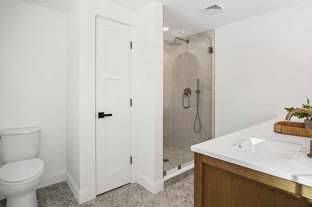 4 Jethro Street Maynard, MA 01754 - Photo 20 of 29 a bathroom with a granite countertop sink a toilet and shower