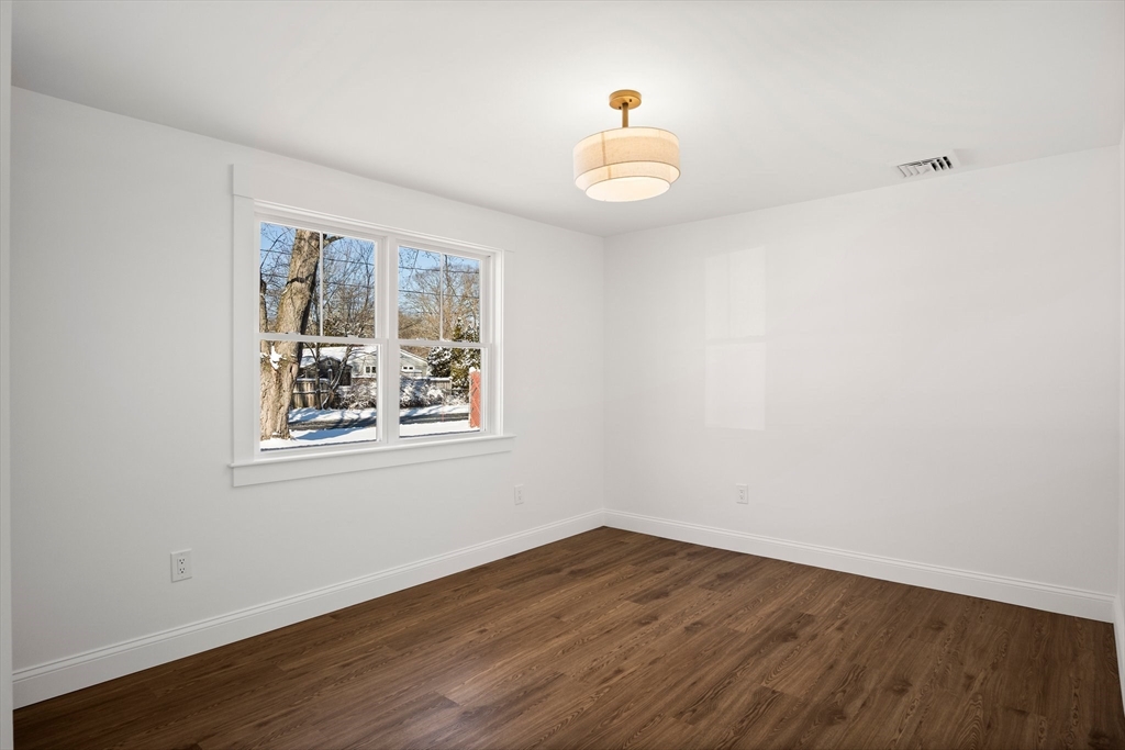 4 Jethro Street Maynard, MA 01754 - Photo 23 of 29 a view of an empty room with wooden floor and a window
