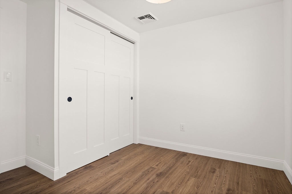 4 Jethro Street Maynard, MA 01754 - Photo 25 of 29 a view of an empty room with wooden floor