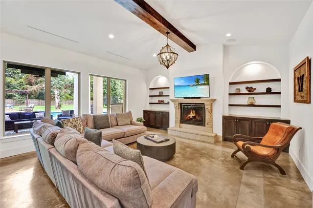 a living room with furniture flat screen tv and a fireplace