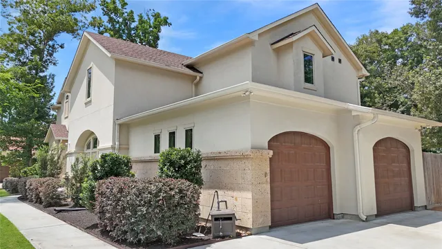 a front view of a house with plants