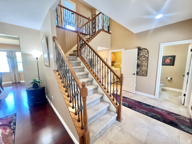 369 Culross Circle Tooele, UT 84074 - Photo 2 of 54 Grand central staircase featuring wood handrails and decorative wrought iron balusters