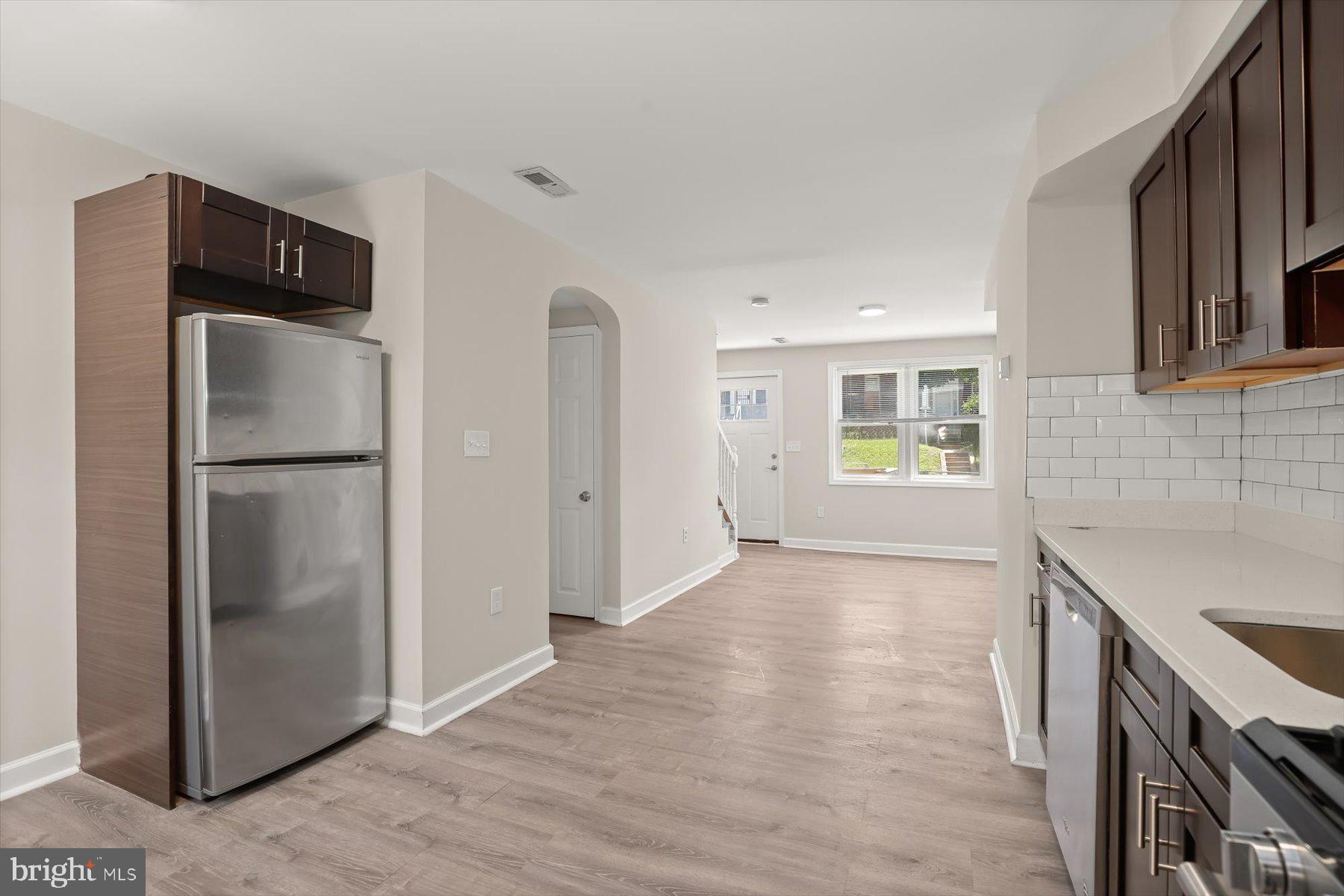 1044 Ellicott Driveway Baltimore, MD 21216 - Photo 9 of 26 a kitchen with stainless steel appliances granite countertop a refrigerator and a sink
