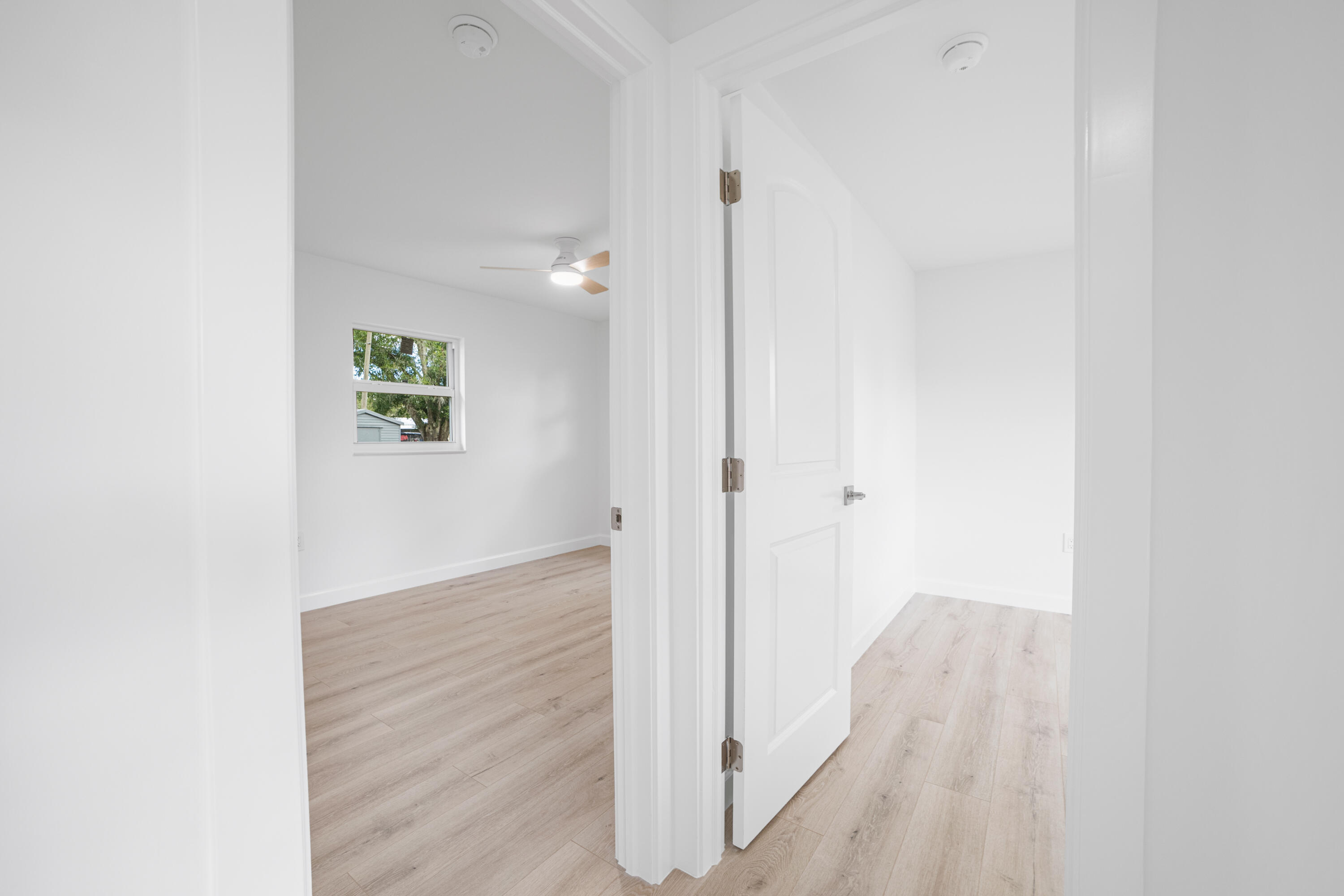 1008 Southwest 10th Street Okeechobee, FL 34974 - Photo 11 of 41 a view of a hallway with wooden floor