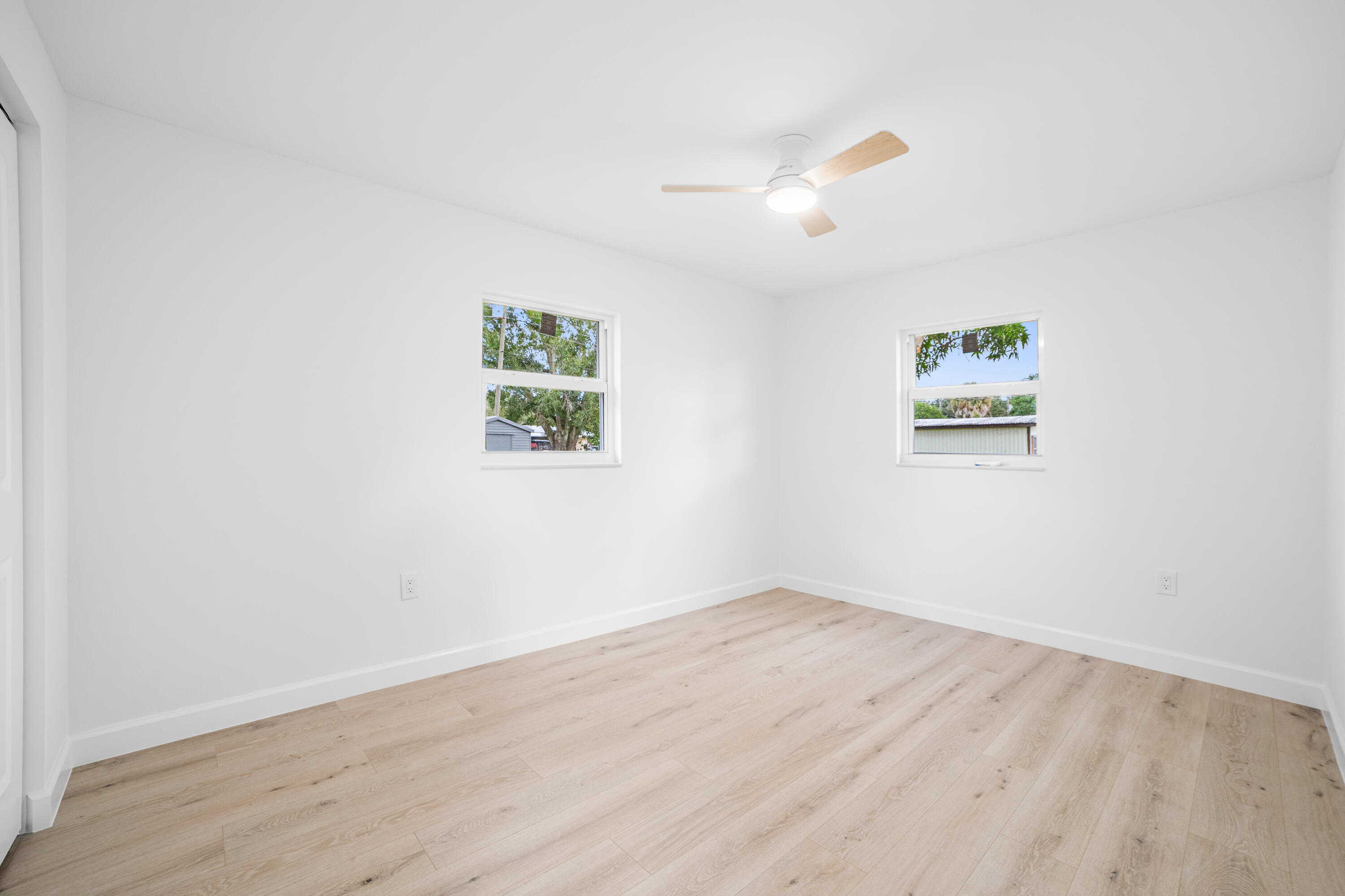 1008 Southwest 10th Street Okeechobee, FL 34974 - Photo 14 of 41 an empty room with wooden floor and window