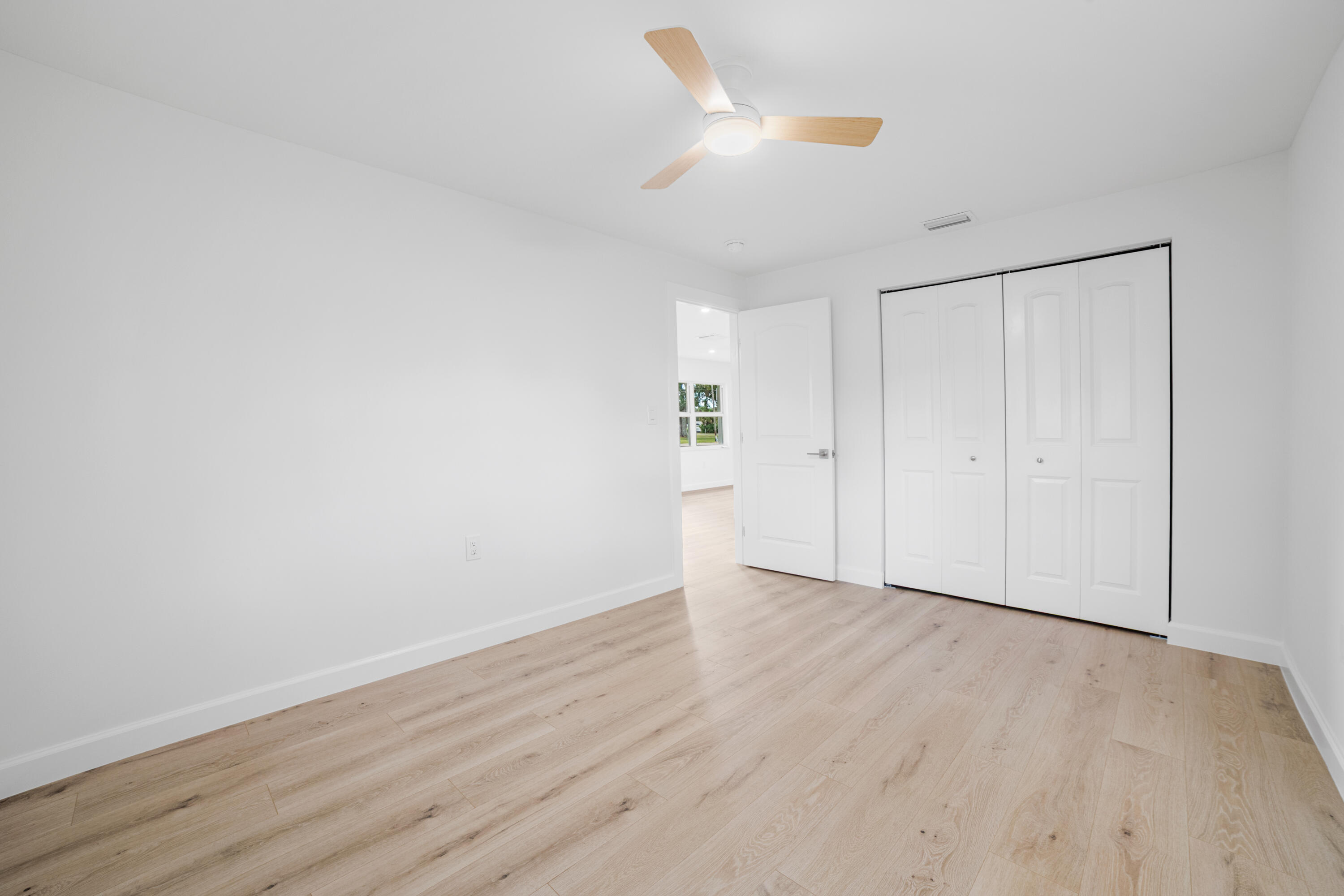 1008 Southwest 10th Street Okeechobee, FL 34974 - Photo 15 of 41 a view of an empty room with wooden floor