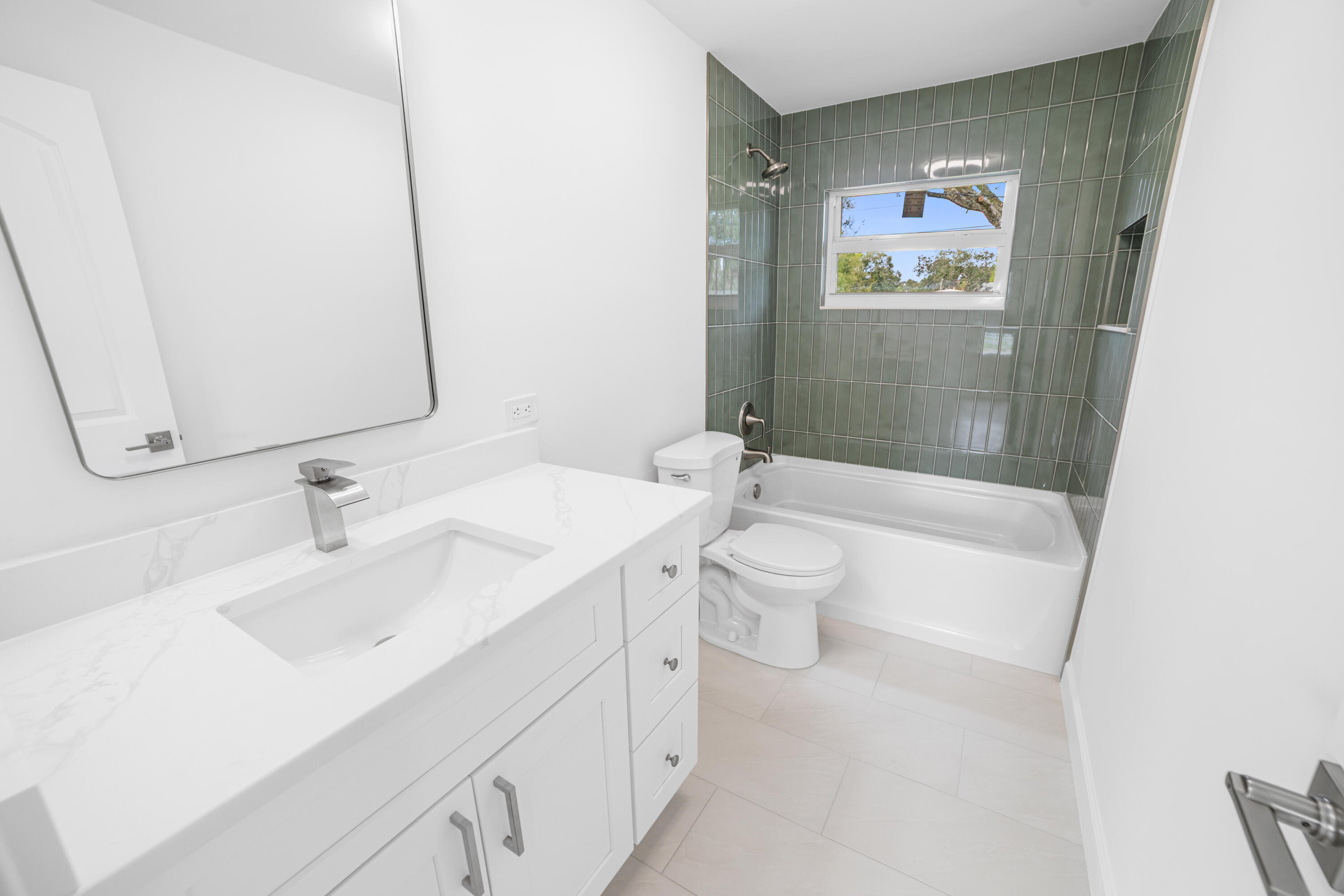 1008 Southwest 10th Street Okeechobee, FL 34974 - Photo 16 of 41 a bathroom with a sink a toilet and shower