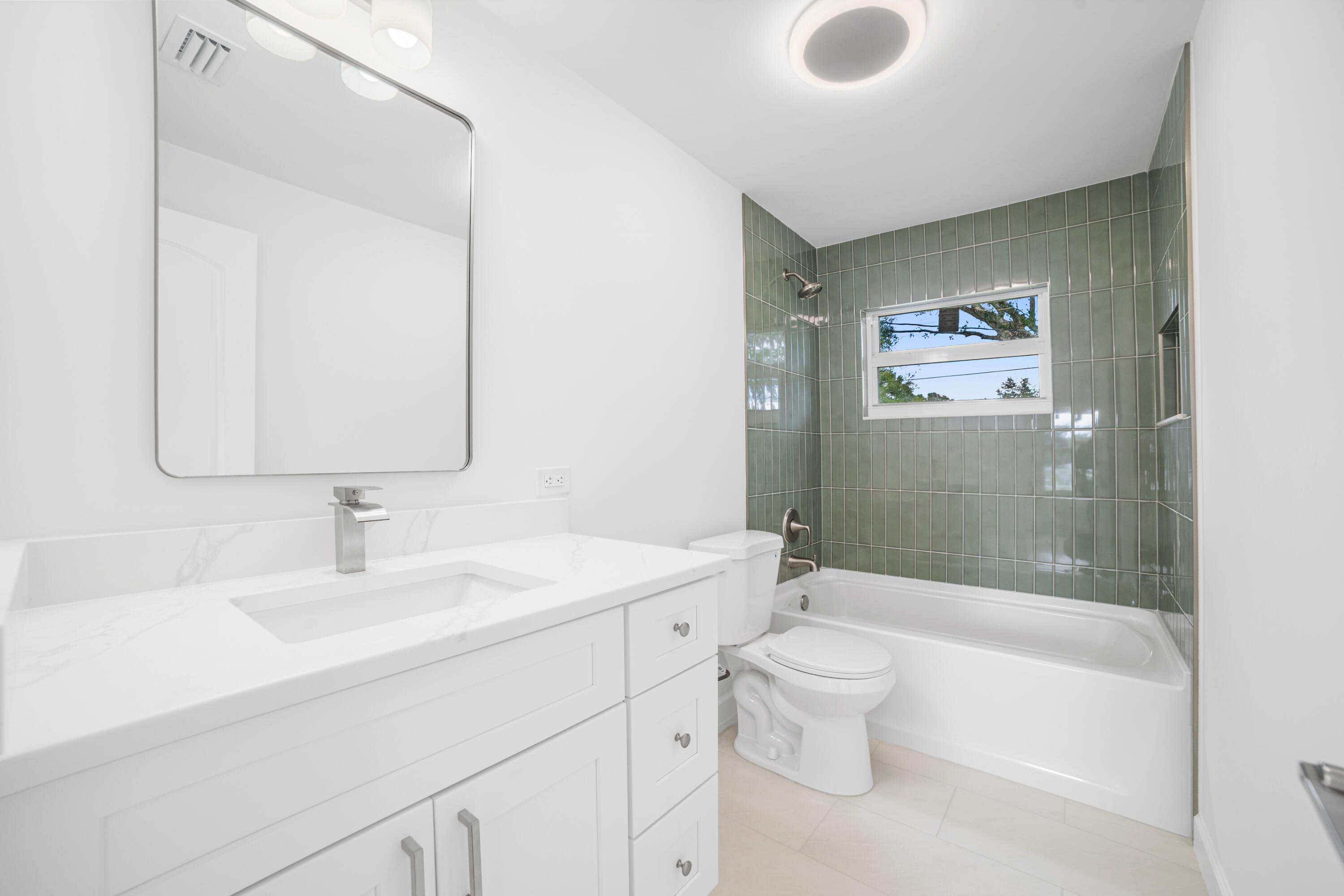 1008 Southwest 10th Street Okeechobee, FL 34974 - Photo 17 of 41 a bathroom with a sink a toilet and shower
