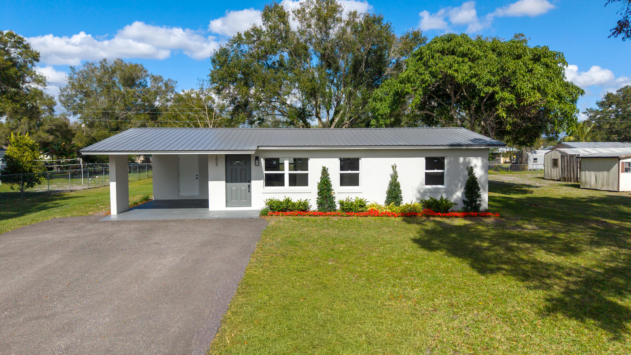 1008 Southwest 10th Street Okeechobee, FL 34974 - Photo 2 of 41 a front view of a house with yard and green space